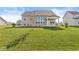 Large backyard showcasing the well-maintained lawn and the home's back exterior at 12894 Corydon Dr, Fishers, IN 46037