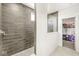 Modern bathroom featuring tiled shower with glass enclosure and closet at 12894 Corydon Dr, Fishers, IN 46037