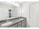 Bathroom with double sinks, granite countertops, large mirror, and neutral paint at 12894 Corydon Dr, Fishers, IN 46037