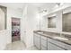 Bright bathroom with double vanity, granite counters, and tile flooring at 12894 Corydon Dr, Fishers, IN 46037