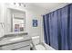 Bathroom featuring granite countertops, a blue shower curtain, and a neutral wall color at 12894 Corydon Dr, Fishers, IN 46037