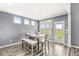 Dining space with a modern table set next to a sliding door and large windows at 12894 Corydon Dr, Fishers, IN 46037
