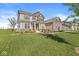 Two-story home featuring neutral siding, a manicured lawn, and attractive landscaping at 12894 Corydon Dr, Fishers, IN 46037