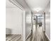 Light and airy hallway with wood floors, leading to a comfortable living space with a view of the outdoors at 12894 Corydon Dr, Fishers, IN 46037