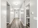 Bright hallway with wood floors and a convenient powder room for guests at 12894 Corydon Dr, Fishers, IN 46037