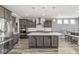 Modern kitchen with stainless steel appliances, a large island, and plenty of cabinet space at 12894 Corydon Dr, Fishers, IN 46037