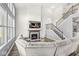 Bright living room boasts a fireplace, TV, and a staircase to the second floor, perfect for Gathering time at 12894 Corydon Dr, Fishers, IN 46037