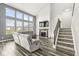 Spacious living area with tall windows providing abundant natural light and a cozy fireplace at 12894 Corydon Dr, Fishers, IN 46037