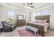 Comfortable main bedroom with a large bed, dresser, and sitting area at 12894 Corydon Dr, Fishers, IN 46037