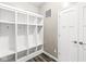 Mudroom with a white cubby storage unit and gray plank flooring at 12894 Corydon Dr, Fishers, IN 46037