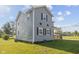 Two-story home features gray siding, black shutters, and a well-maintained lawn at 13 N Main St, Brooklyn, IN 46111