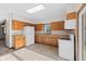 Kitchen features wood cabinets, laminate countertops, and white appliances at 13 N Main St, Brooklyn, IN 46111