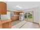 The Kitchen features wood cabinets, white appliances, and a sliding glass door at 13 N Main St, Brooklyn, IN 46111