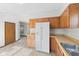 Bright kitchen features wood cabinets, and a white refrigerator at 13 N Main St, Brooklyn, IN 46111