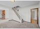 Open-concept living room featuring stairs, a fireplace, and neutral-toned walls at 13 N Main St, Brooklyn, IN 46111