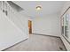 Bright living room with new carpet, a staircase, and natural light from a window at 13 N Main St, Brooklyn, IN 46111