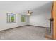 Large room featuring two windows, neutral carpet, and a brick fireplace at 13 N Main St, Brooklyn, IN 46111