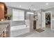 Elegant bathroom featuring soaking tub and separate shower with glass enclosure at 1533 Windswept, Brownsburg, IN 46112