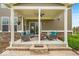 Inviting covered patio with comfortable seating and decorative landscaping at 1533 Windswept, Brownsburg, IN 46112