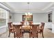Formal dining room featuring elegant lighting, wainscoting, and a large window at 1533 Windswept, Brownsburg, IN 46112