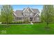 Charming brick and stone home with professionally landscaped front yard and welcoming covered front porch at 1533 Windswept, Brownsburg, IN 46112