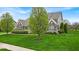 Desirable suburban home showcasing pristine landscaping, lush lawn and brick and stone exterior, with side entry garage at 1533 Windswept, Brownsburg, IN 46112