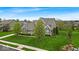 Landscaped lawn surrounds this beautiful two-story home on a sunny day at 1533 Windswept, Brownsburg, IN 46112