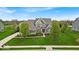 Beautiful two-story home featuring lush green lawn, mature trees, and tasteful landscaping at 1533 Windswept, Brownsburg, IN 46112