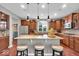 Stylish kitchen with wooden cabinets, granite countertops, and an island with seating at 1533 Windswept, Brownsburg, IN 46112