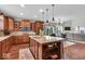 Open kitchen with island, stainless appliances, seamlessly flowing into living and dining areas at 1533 Windswept, Brownsburg, IN 46112