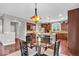 Spacious kitchen with warm wood cabinetry and a cozy dining area with unique lighting fixture at 1533 Windswept, Brownsburg, IN 46112