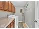 Well-lit laundry room with ample cabinet space, washer, and dryer at 1533 Windswept, Brownsburg, IN 46112