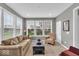 Cozy living room bathed in natural light through large windows with comfortable furnishings at 1533 Windswept, Brownsburg, IN 46112