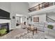 Spacious living room featuring a fireplace, vaulted ceiling, and access to the upper floor at 1533 Windswept, Brownsburg, IN 46112