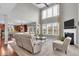 Bright living room with vaulted ceilings, large windows, and a cozy fireplace at 1533 Windswept, Brownsburg, IN 46112