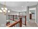 Spacious loft area with elegant chandelier and hardwood floors on the lower level at 1533 Windswept, Brownsburg, IN 46112