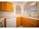 Bright kitchen featuring light wood cabinets, neutral countertops, and a view to the living space at 1575 Sierra Springs, Carmel, IN 46280