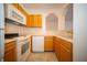 Well-lit kitchen featuring white appliances, light wood cabinets, and ample counter space at 1575 Sierra Springs, Carmel, IN 46280
