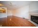 Spacious living room boasting hardwood floors, a fireplace, and a partial view of the kitchen at 1575 Sierra Springs, Carmel, IN 46280