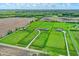 An expansive green estate featuring multiple homes with long driveways, manicured lawns, and agricultural fields nearby at 1581 S 825 E, Zionsville, IN 46077