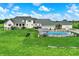 Expansive lawn featuring a home with an in-ground pool, outdoor kitchen, and plenty of space for recreation at 1581 S 825 E, Zionsville, IN 46077