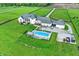 A large backyard features a sparkling inground pool, patio, and ample green space perfect for outdoor entertaining at 1581 S 825 E, Zionsville, IN 46077