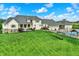 Lush lawn features an inground pool, outdoor kitchen, and large home with stone accents at 1581 S 825 E, Zionsville, IN 46077