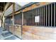 Well-maintained barn stalls with wooden construction and metal bars, offering a safe and secure environment at 1581 S 825 E, Zionsville, IN 46077