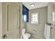 Well-lit bathroom with a toilet, towels and a window to bring in natural light at 1581 S 825 E, Zionsville, IN 46077