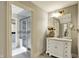 Bathroom vanity with white cabinetry, marble countertops, and framed mirror at 1581 S 825 E, Zionsville, IN 46077