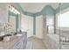 Bright bathroom with marble tile, gray cabinets, double sinks, and a separate soaking tub at 1581 S 825 E, Zionsville, IN 46077