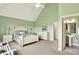 Spacious bedroom with green walls, ceiling fan, and ensuite bathroom at 1581 S 825 E, Zionsville, IN 46077