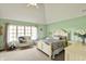 Bright bedroom with large windows, neutral carpet, vaulted ceiling, ceiling fan, and bench at 1581 S 825 E, Zionsville, IN 46077
