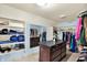Walk-in closet with storage shelves, racks, drawers, and a center island for organization at 1581 S 825 E, Zionsville, IN 46077